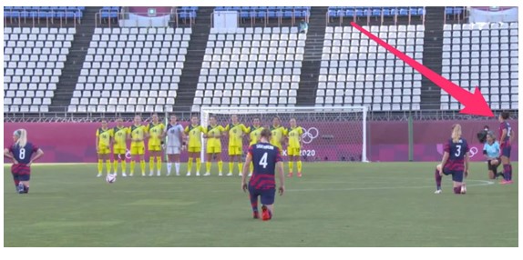 Picture showing Carli standing during national anthem